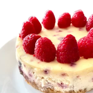 White Chocolate Raspberry Cheesecake Recipe White Chocolate Raspberry Cheesecake with raspberries circling the top edge
